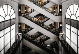 escalators criss cross in distance of high windowed atrium