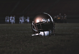 football helmet sitting on turf in football field