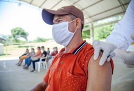 man receiving a vaccination at an outdoor popup vaccination clinic